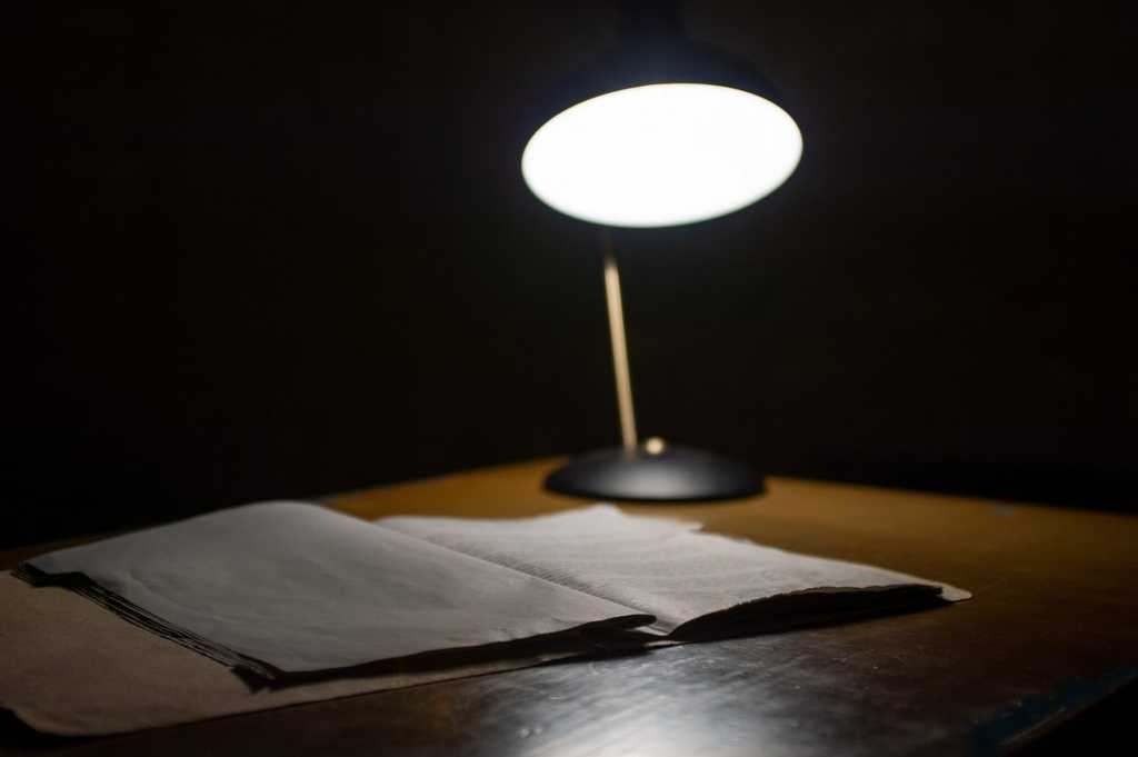 Investigations documentation on table next to lamp