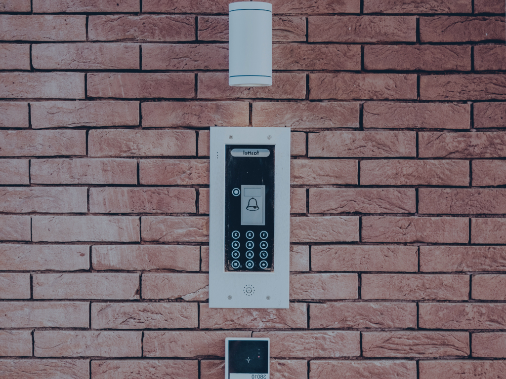 Alarm keypad mounted on face brick wall