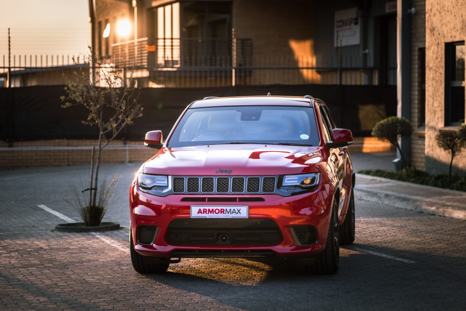 Armoured Red Jeep Trackhawk in parking area