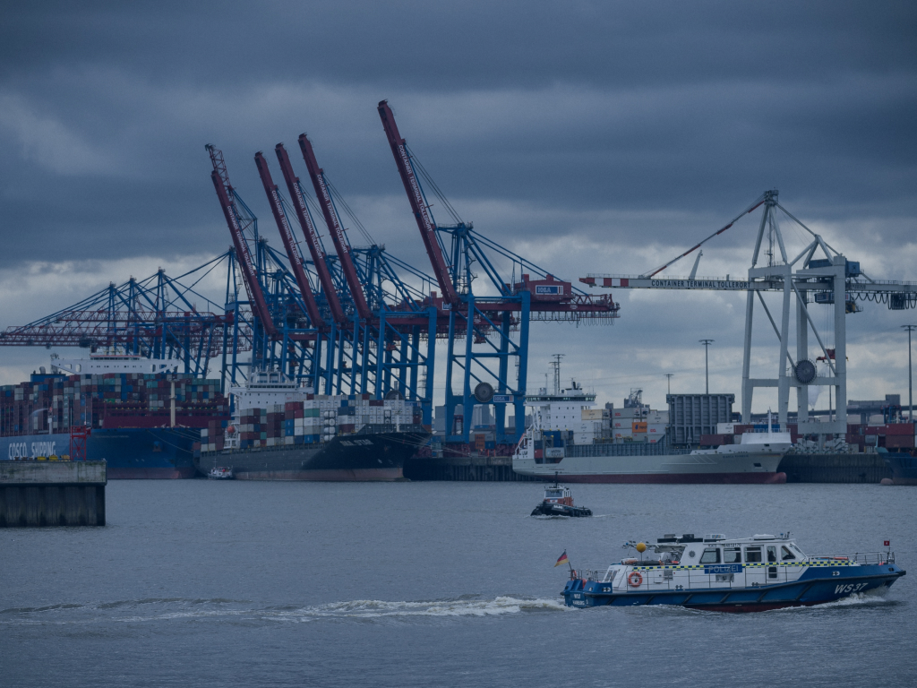 Coast guard boat patrolling container port